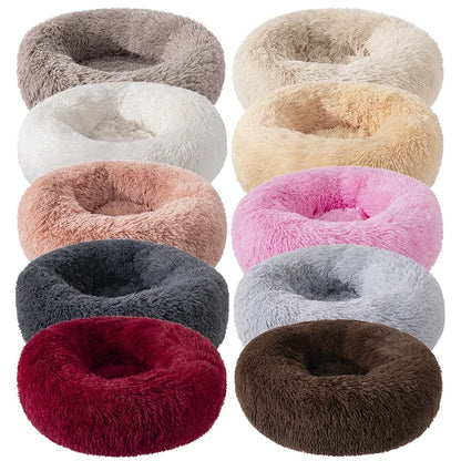 Collection of fluffy donut-shaped pet beds in various colors on a white background