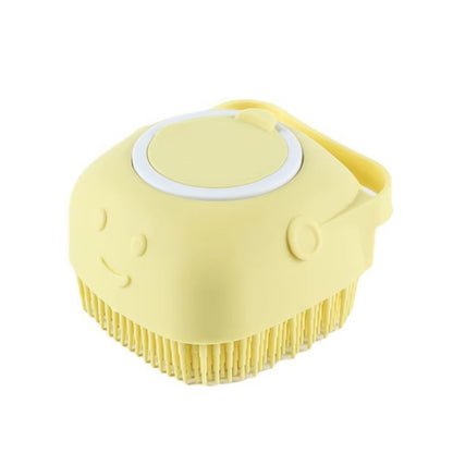 Yellow grooming brush with a white handle on a white background